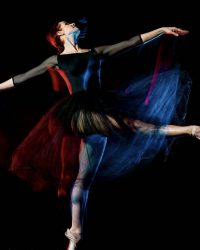 one caucasian woman ballerina classical ballet dancer dancing woman studio shot isolated on black bacground